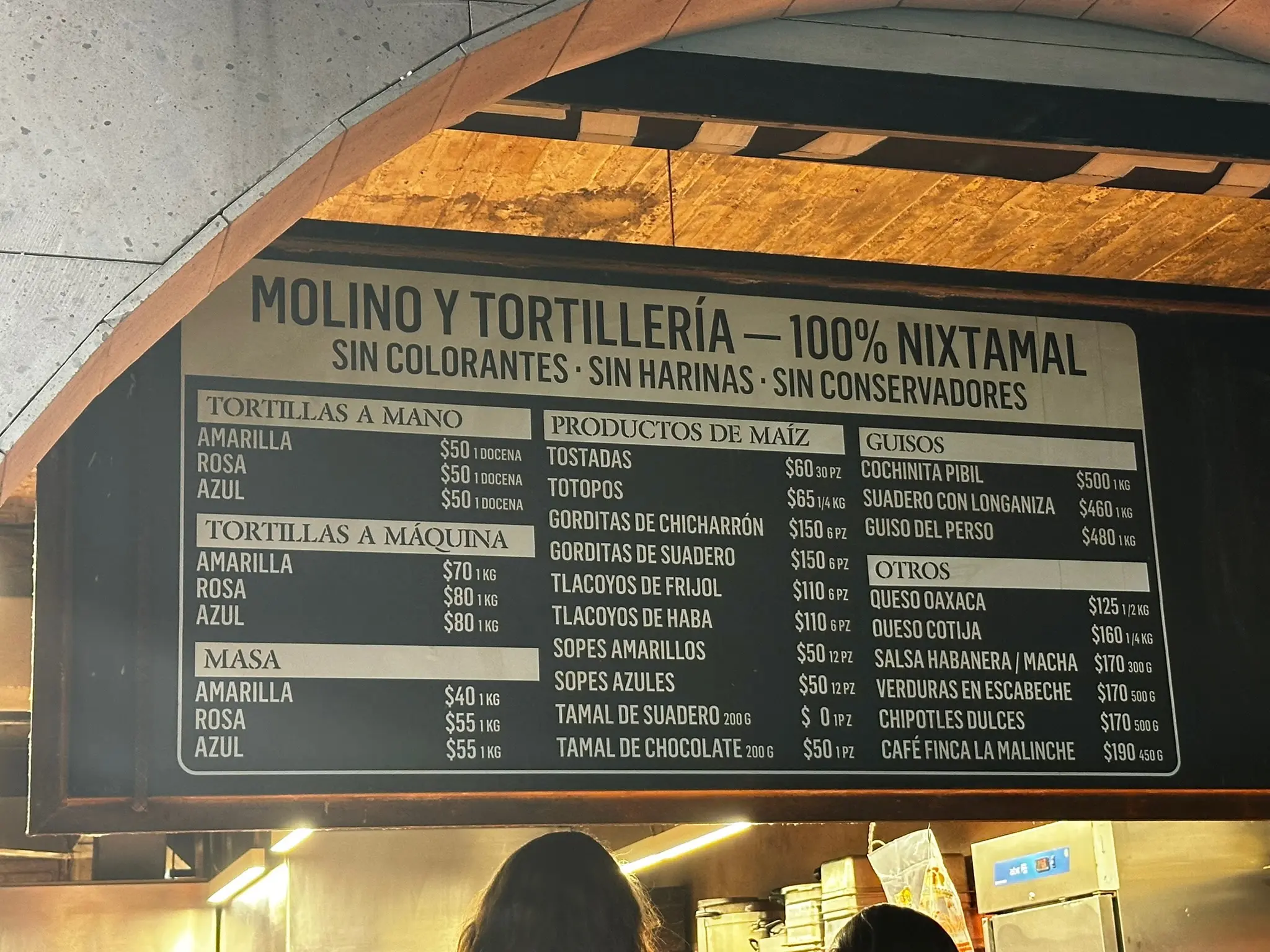 A sign above Maizajo's to-go window showing all of their options and their prices.
